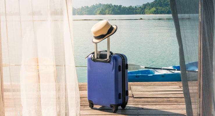 Employees-using-vacation-time-with-a-blue-suitcase-and-hat
