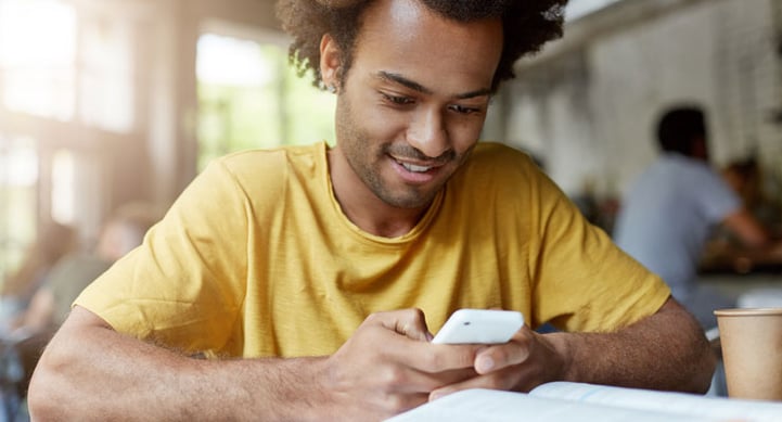 african-american-male-student-looking-up-lsat-tips-on-his-phone